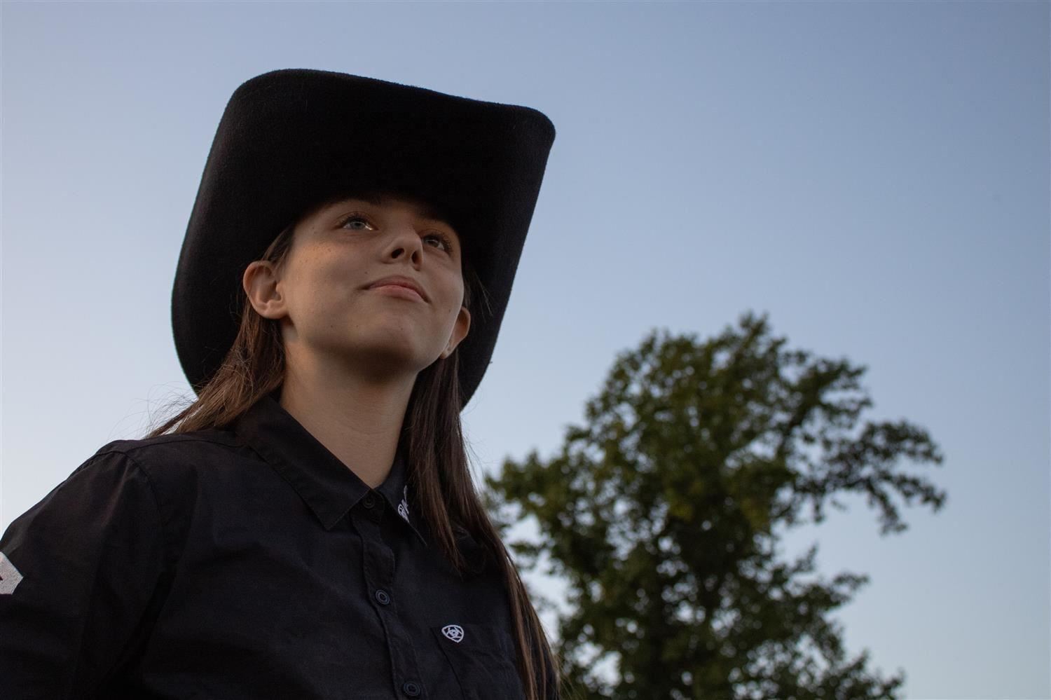 Cowgirl with black hat