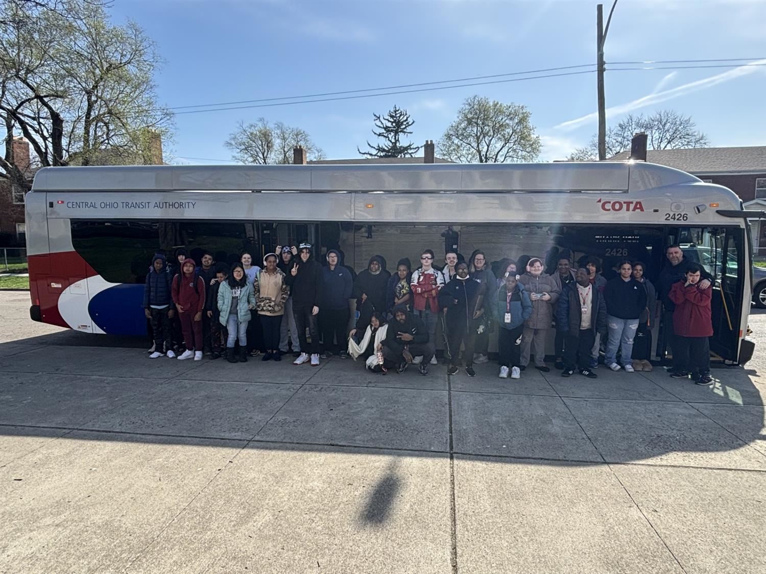 kids in front of a big bus