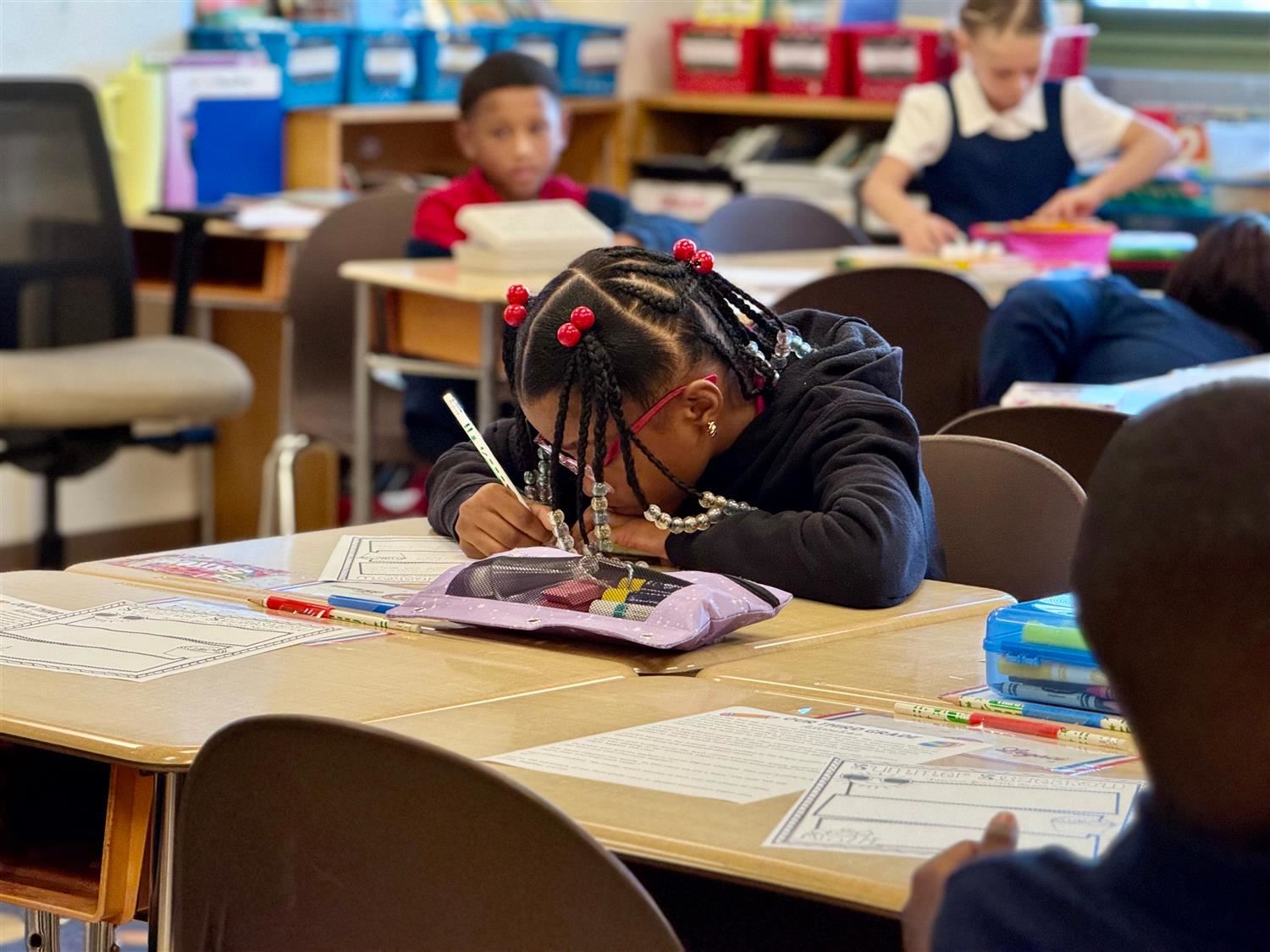 student writing at desk