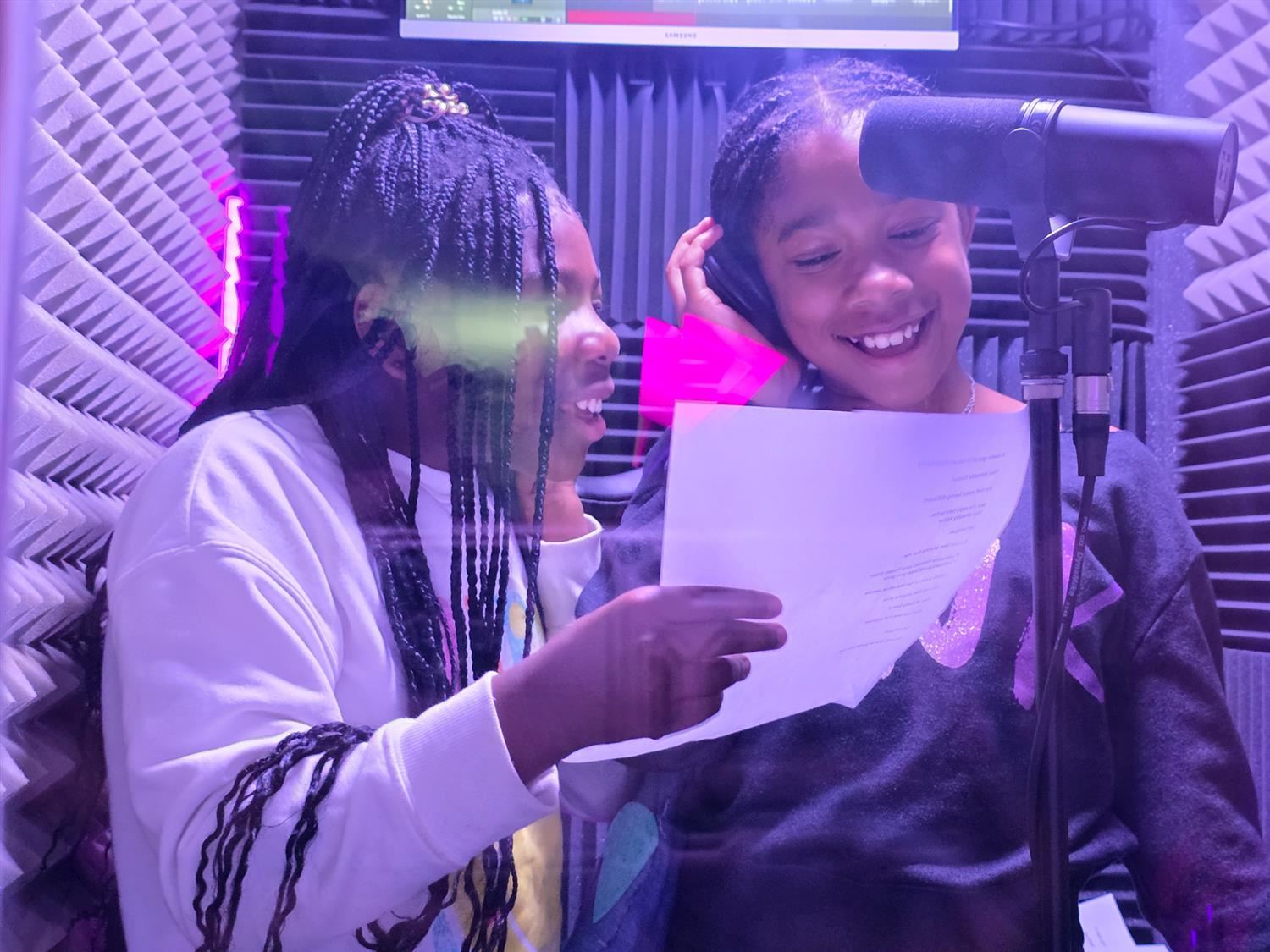 two students in a recording studio