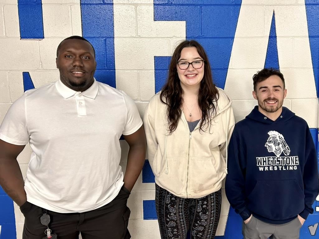 female athlete poses with coaches