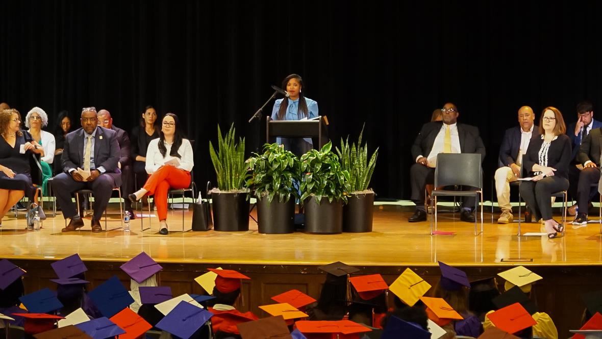 superintendent speaking to a crowd of graduates