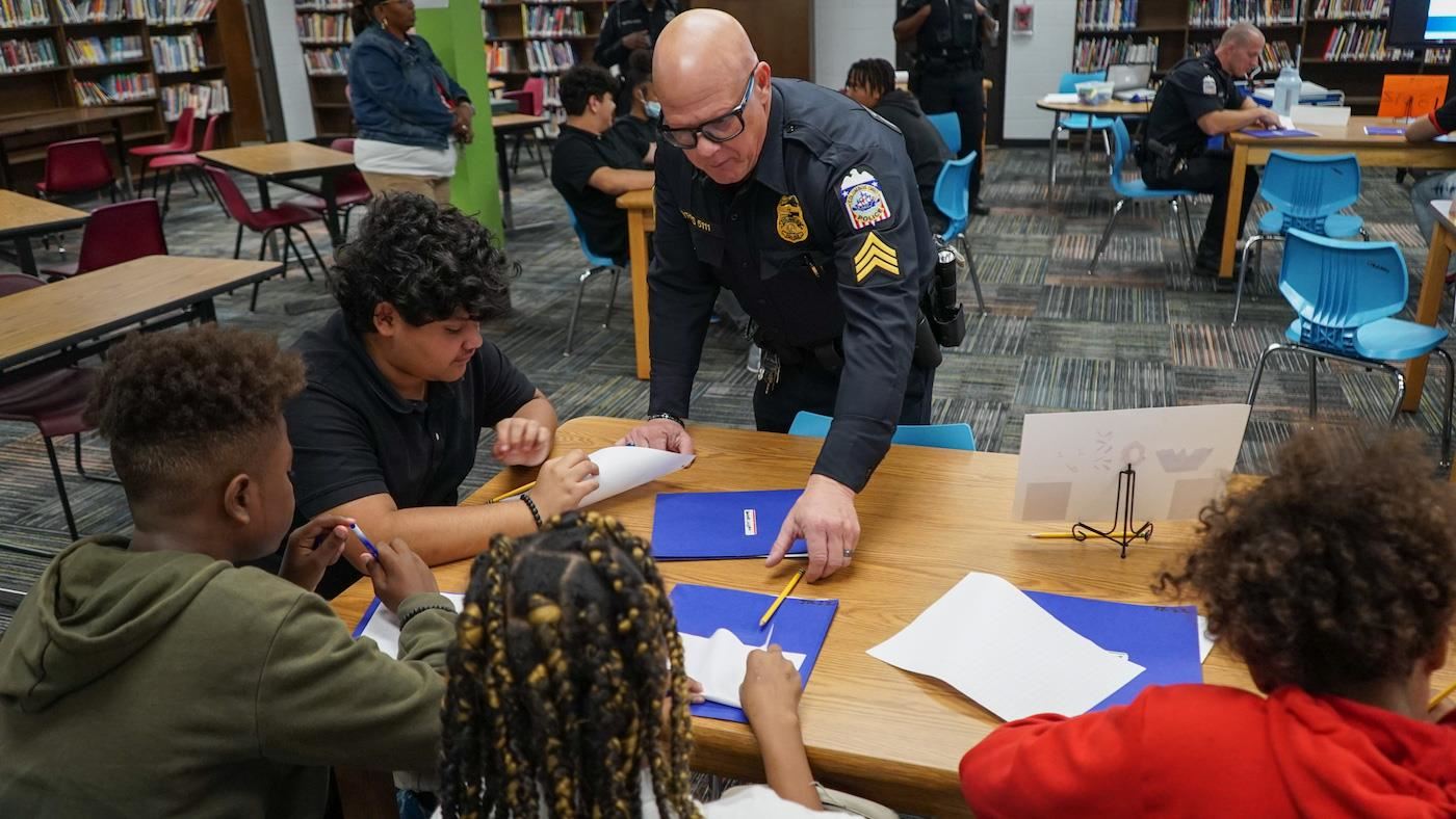 Officer working with students