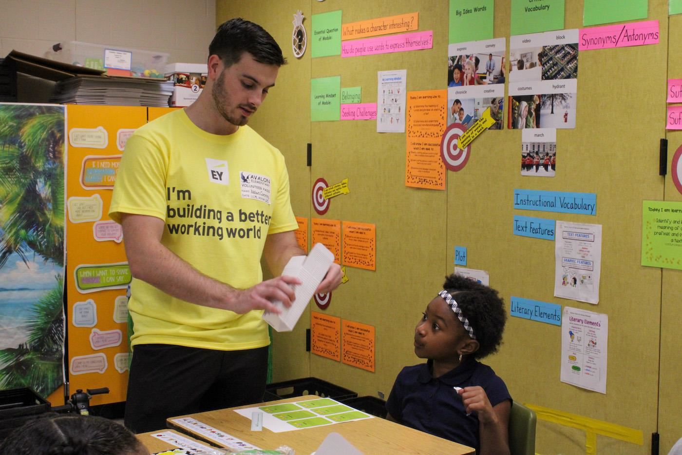 Ernst and Young staff working with student