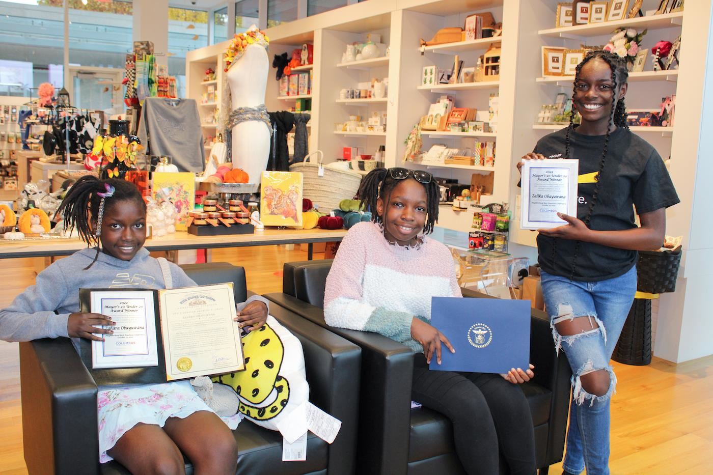 The Obayuwana sisters holding awards