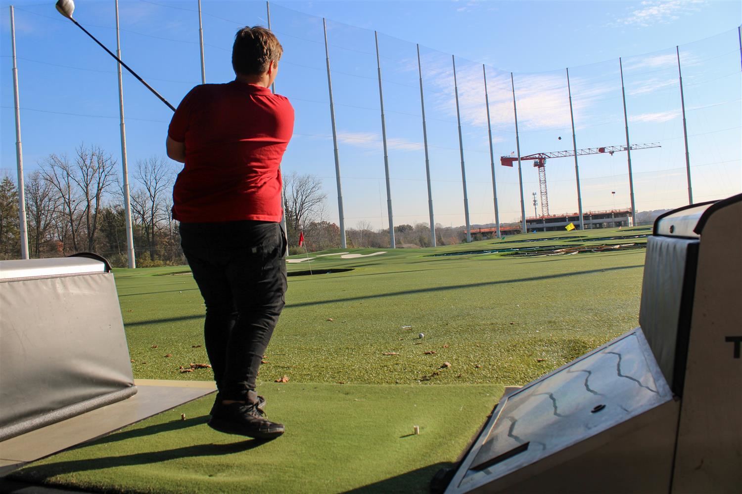 boy swinging golf club