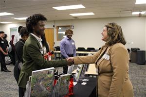 student and professional shaking hands