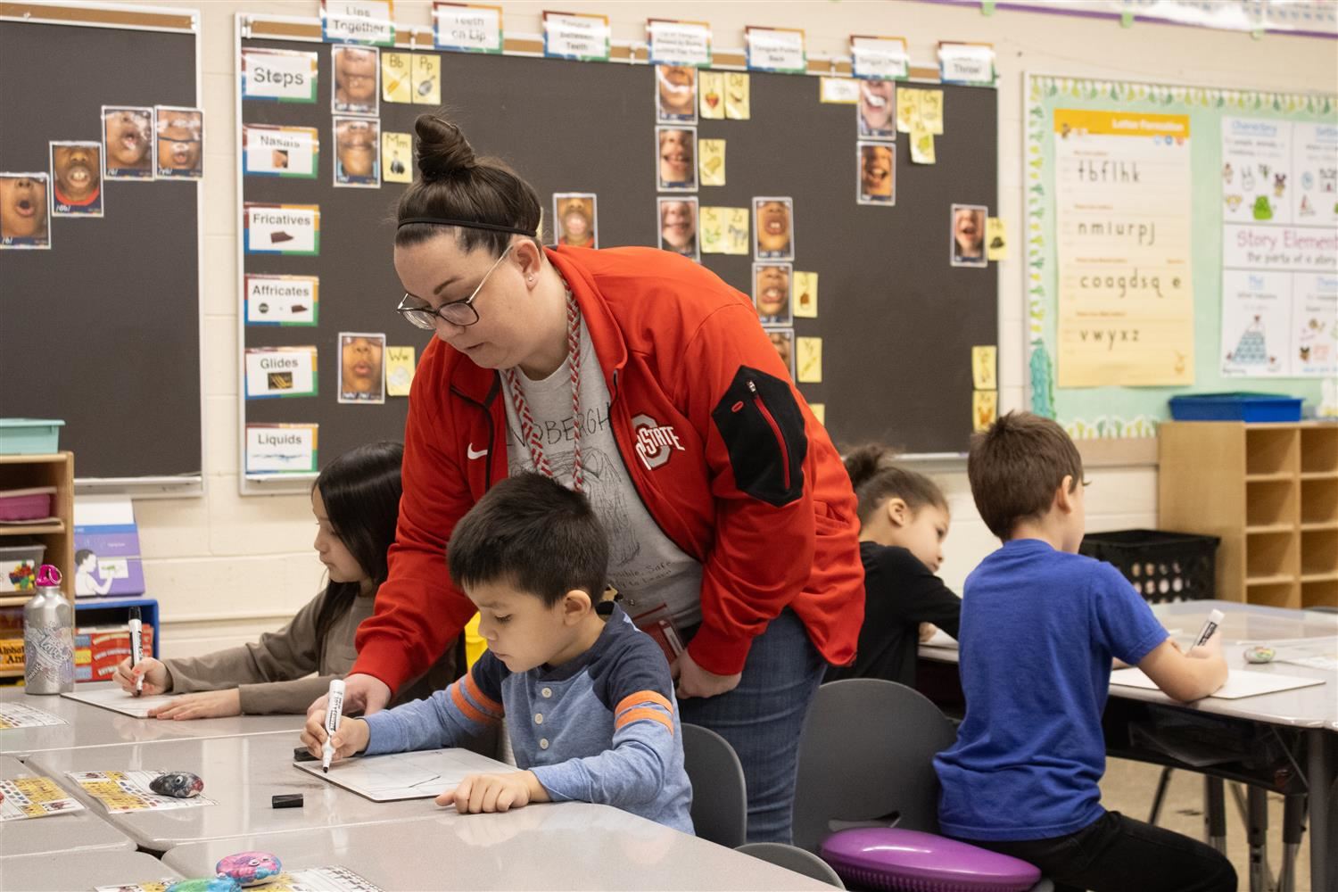 teacher helping student write