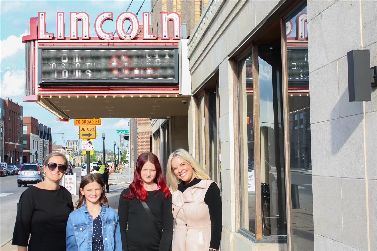 four women standing outside of the Lincoln Theater