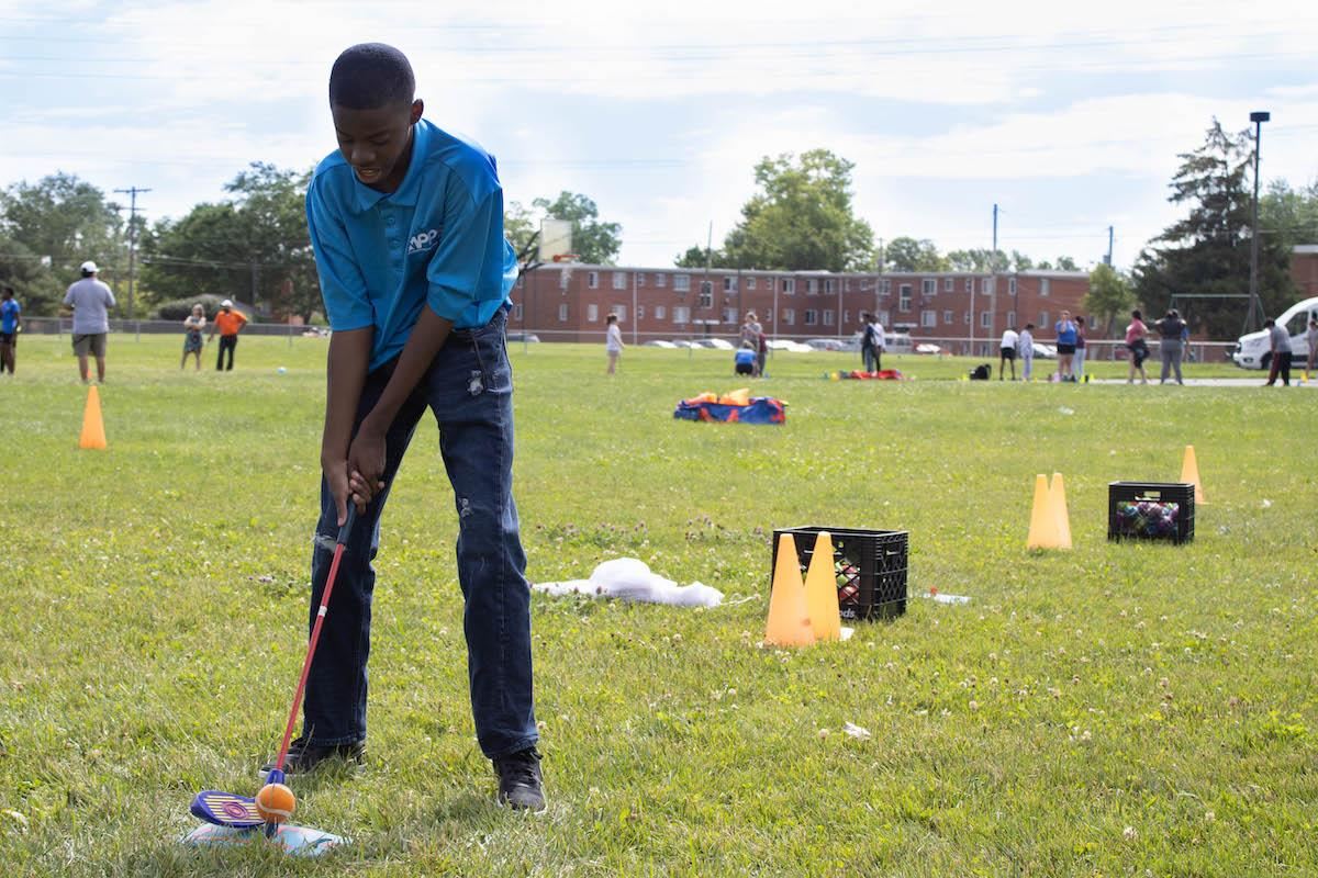 Student golfing