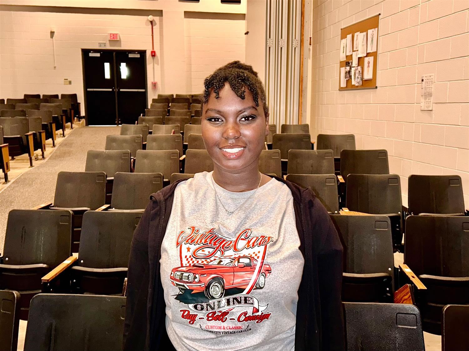 student smiling in auditorium