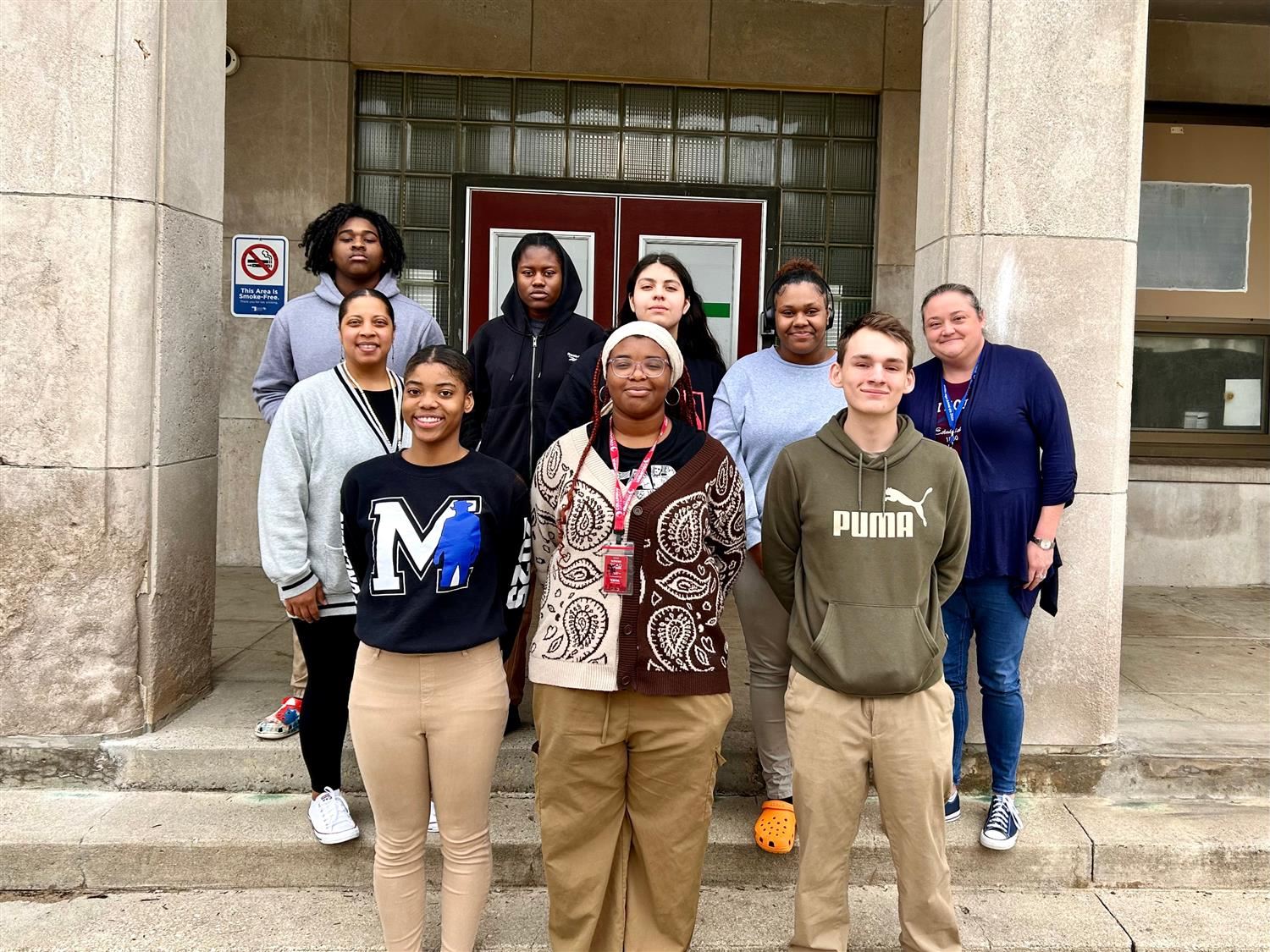 group od students standing in front of school building