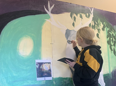  Student paints on a display