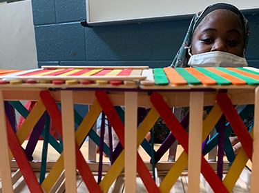  Children design structures with popsicle sticks