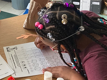  Young learner practices math equations