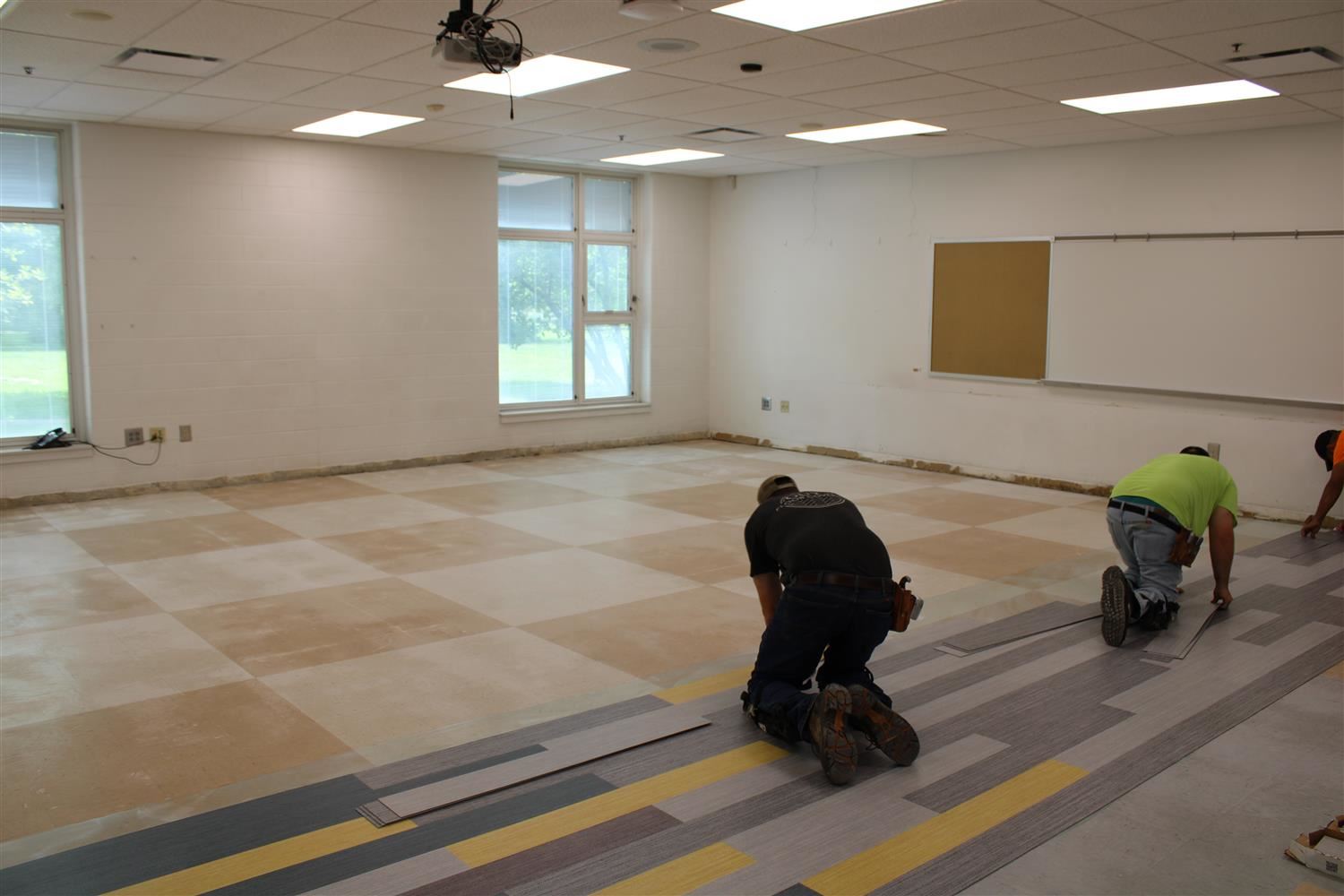 construction crew laying floor 
